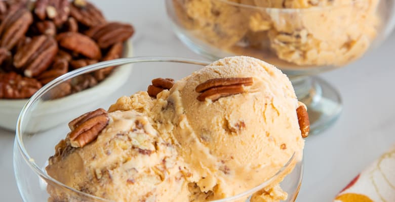 The finished Sweet Potato Butter Pecan Frozen Custard is scooped into footed dessert goblets.