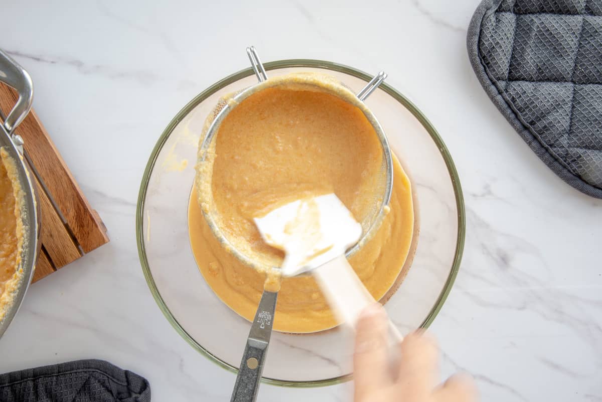 The frozen custard base is strain to remove clumps of sweet potatoes.