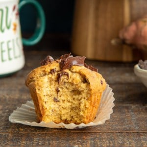 A bite is taken out of a Sweet Potato Chocolate Chunk Muffin