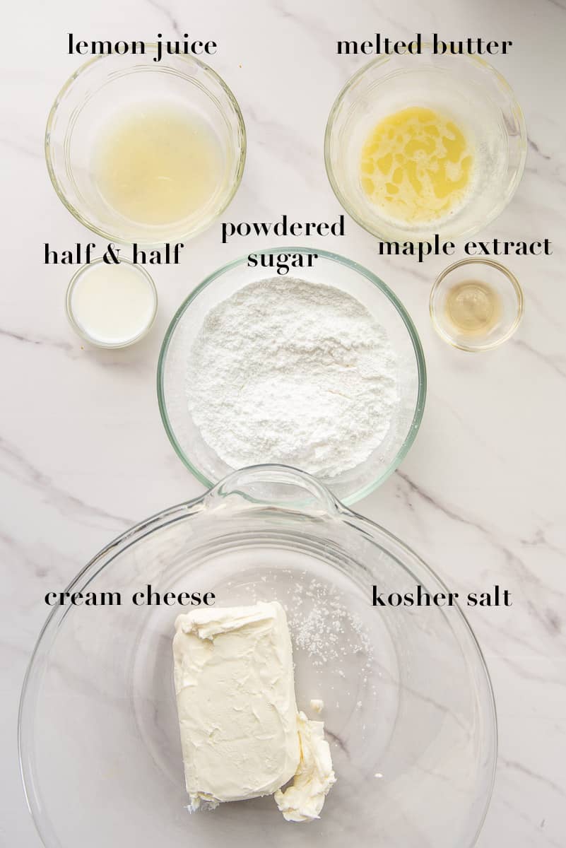 The ingredients to make the cream cheese glaze are labeled and on a white countertop.