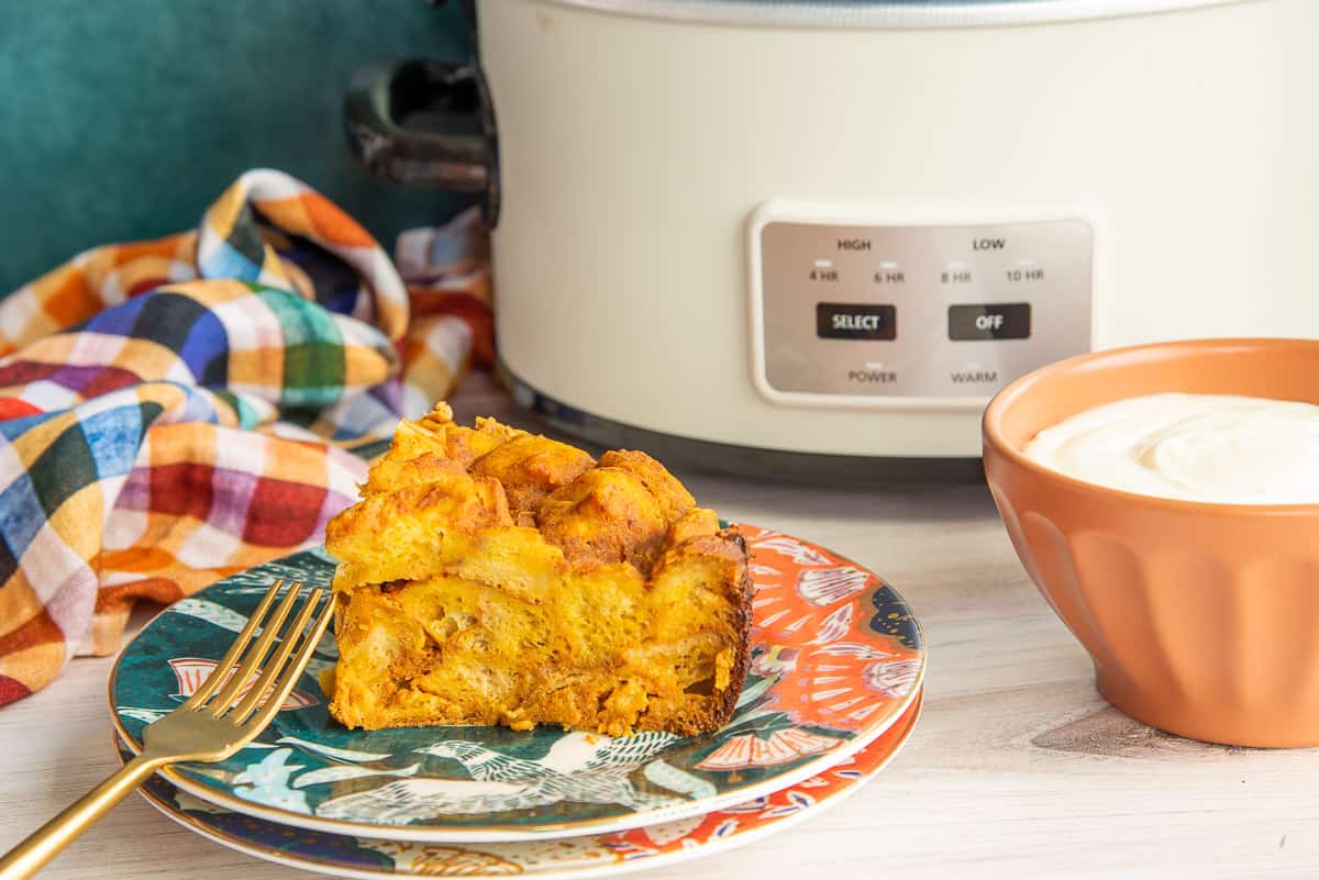 A portion of Slow Cooker Pumpkin French Toast on a colorful plate.