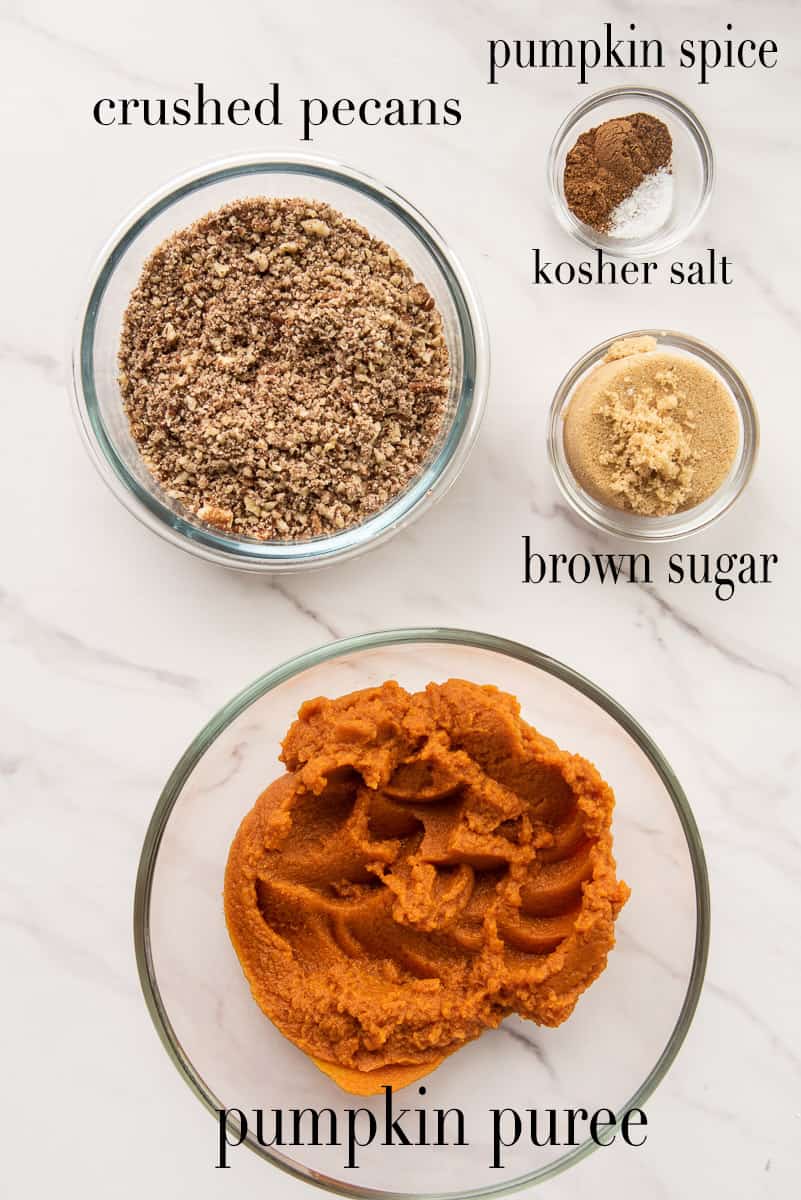 The ingredients to make the pumpkin pecan schmear are on a white countertop.