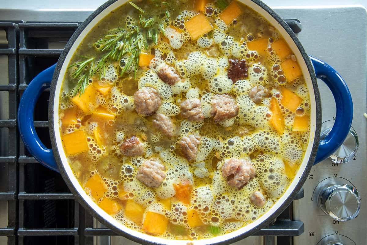 The sausage meatballs are returned to the dutch oven with the rest of the ingredients.