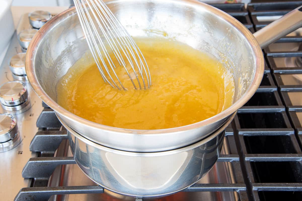 A whisk is used to stir the zabaglione as it cooks over in a double boiler.