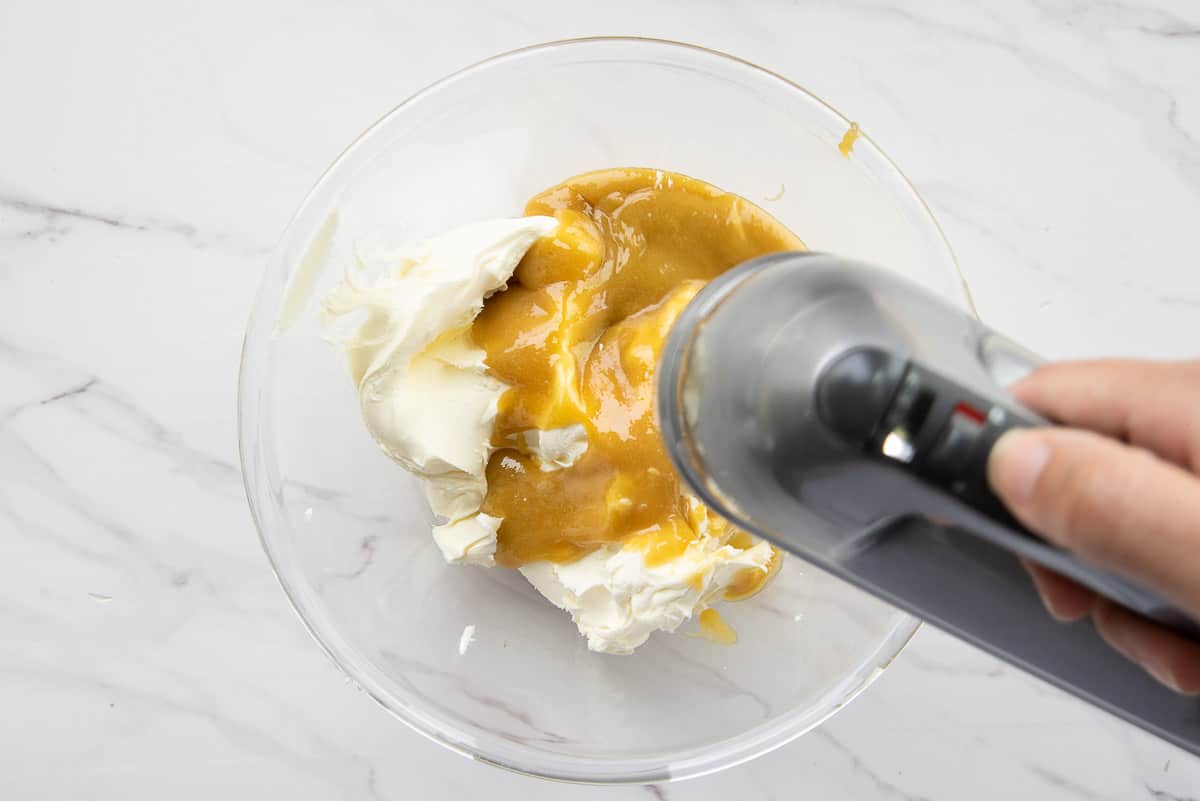 The zabaglione is blended into the mascarpone cheese with a hand mixer.