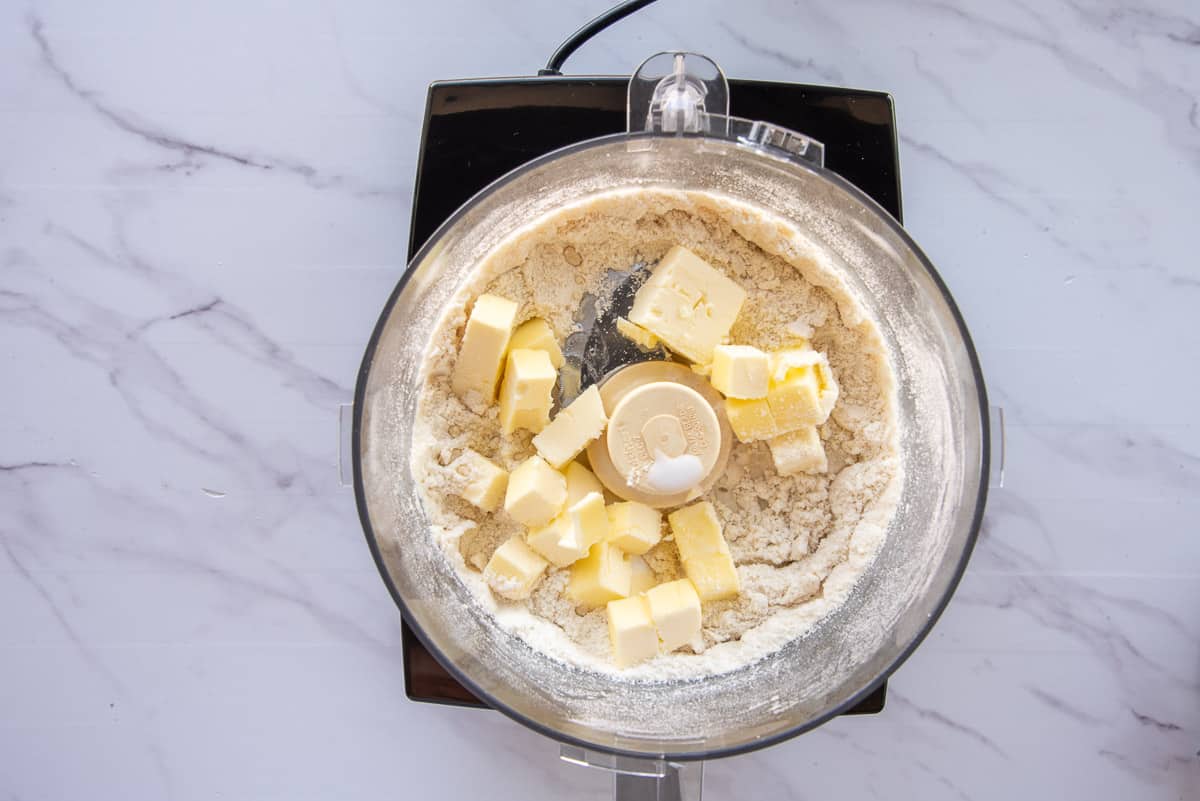 The butter, milk, and almond extract are added to the food processor with the flours, sugar, and salt.