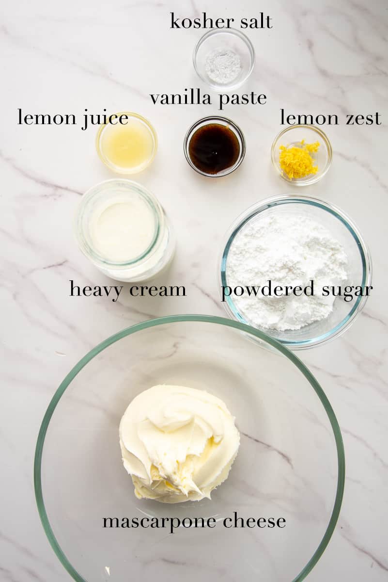The ingredients to make the mascarpone filling are labeled and on a white countertop.