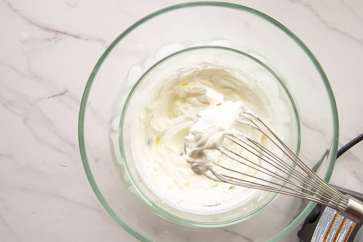 Heavy cream is whipped to stiff peak with an electric hand mixer.