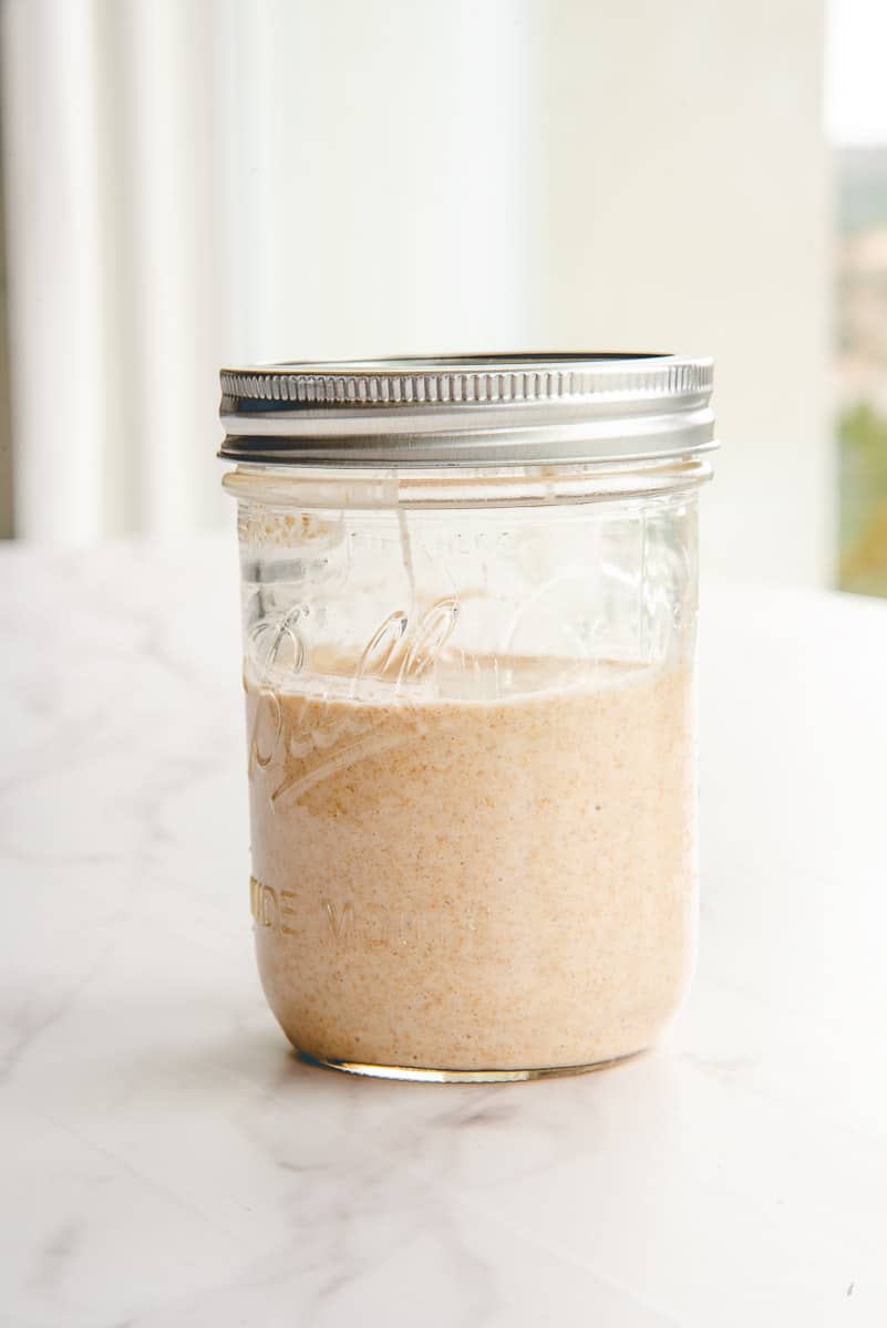 The prepared Rye Sourdough Starter in a glass jar is ready to use.