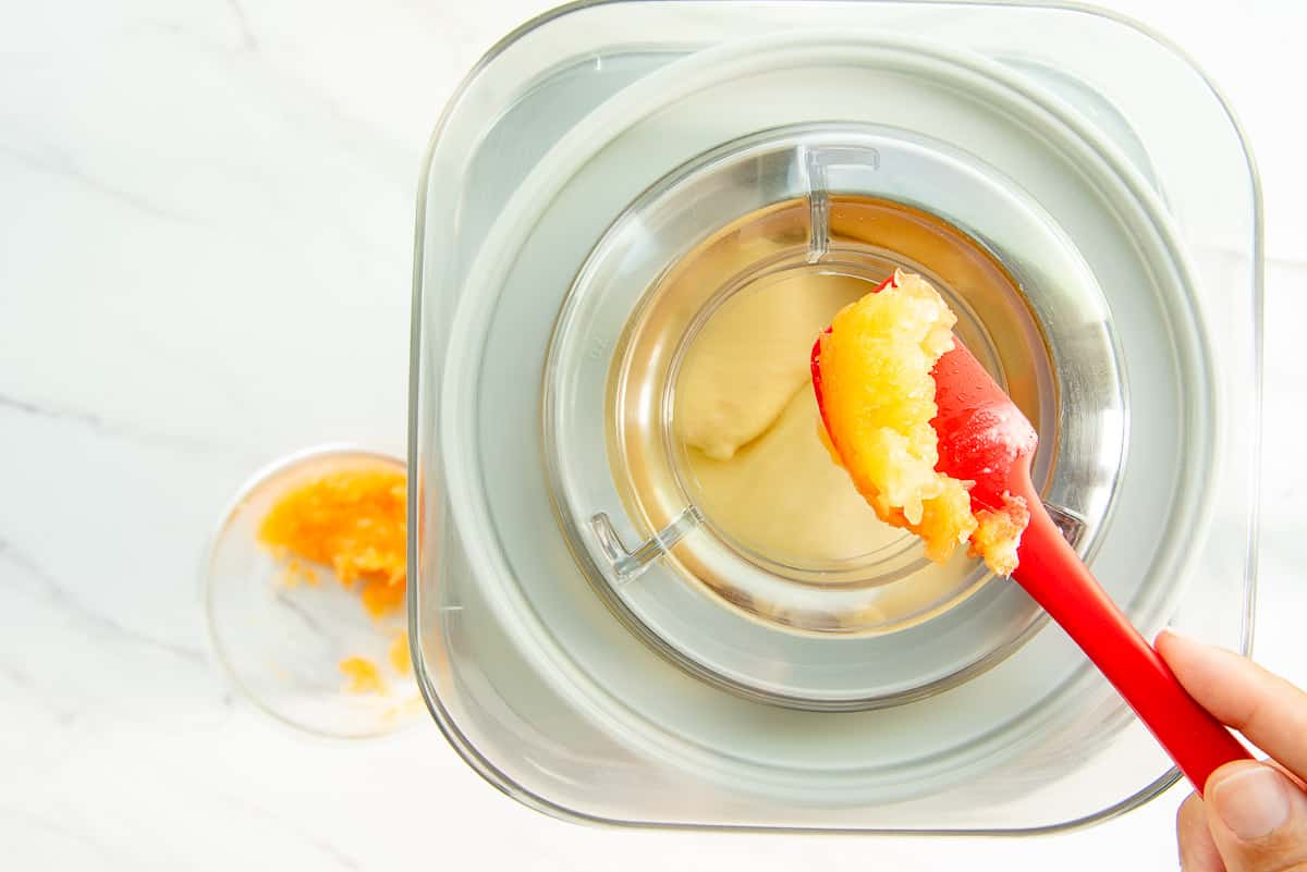 The shredded cantaloupe is added to an ice cream mixer backspace machine turning the frozen custard mixture.