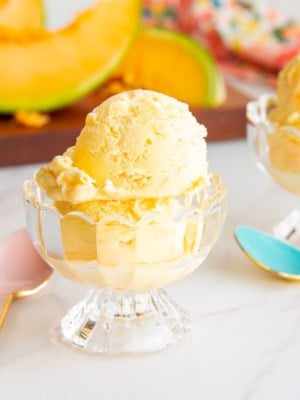 Scoops of cantaloupe frozen custard in clear glass dessert cups.
