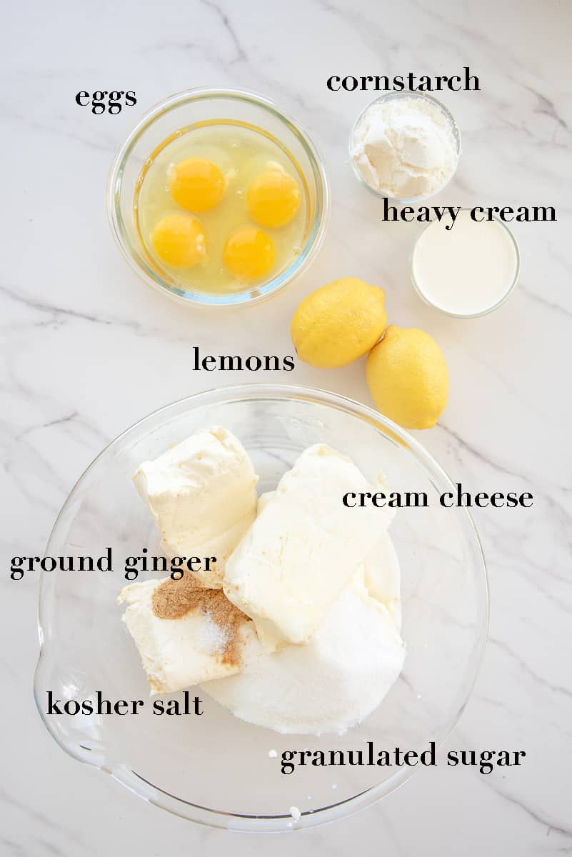 The ingredients needed to make the lemon meringue cheesecake batter on a white countertop.