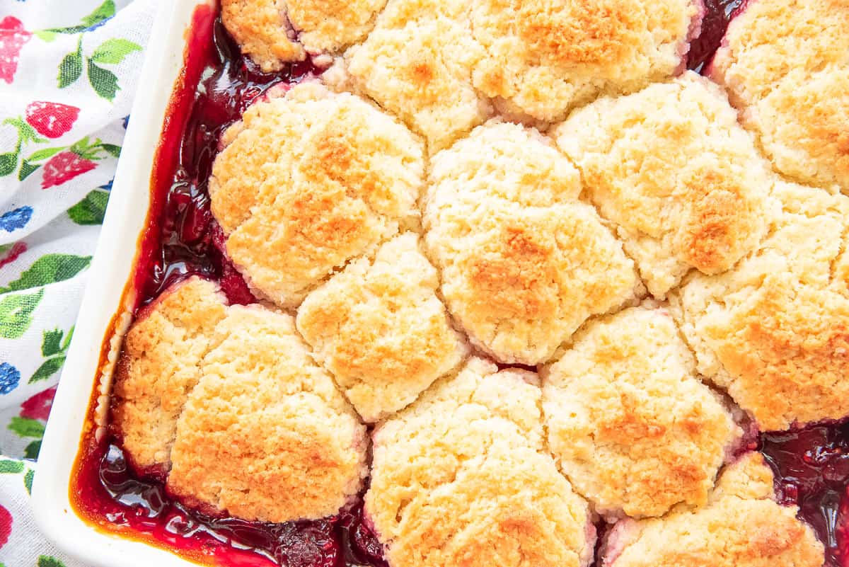A close up of the raspberry cobbler with baked topping.