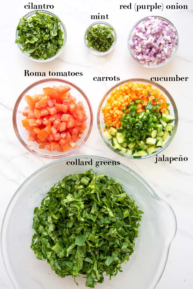 The ingredients for the rest of the black eyed peas salad with collard greens on a white countertop. The ingredients are labeled with black text.