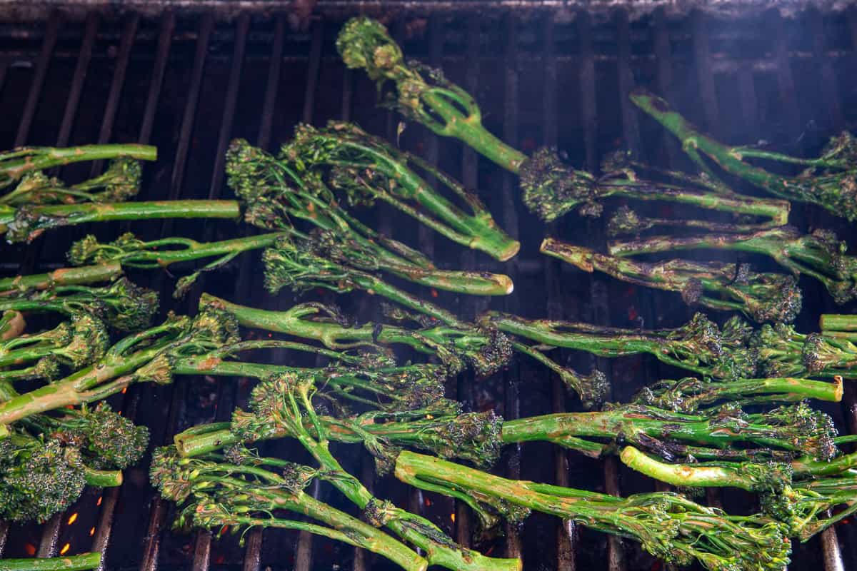 Charring the vegetables on the grill.