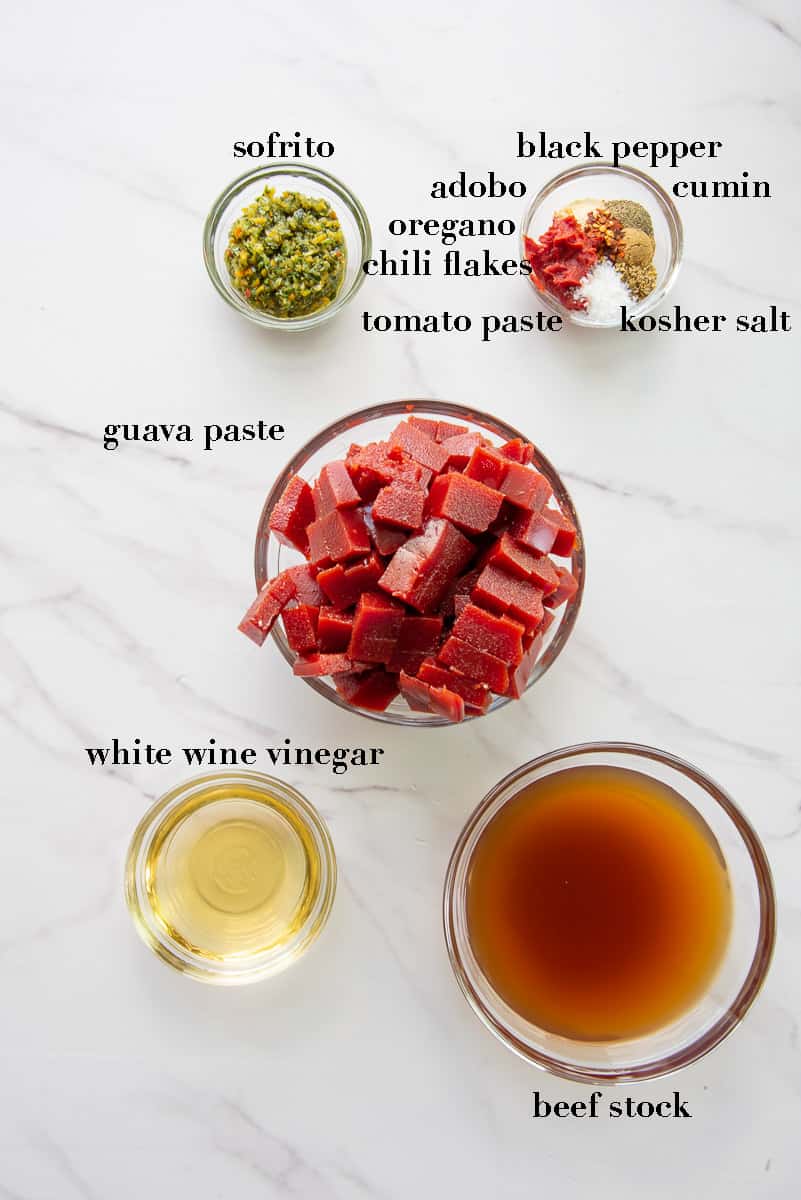 The ingredients needed to make the guava sauce are labeled and on a white countertop.