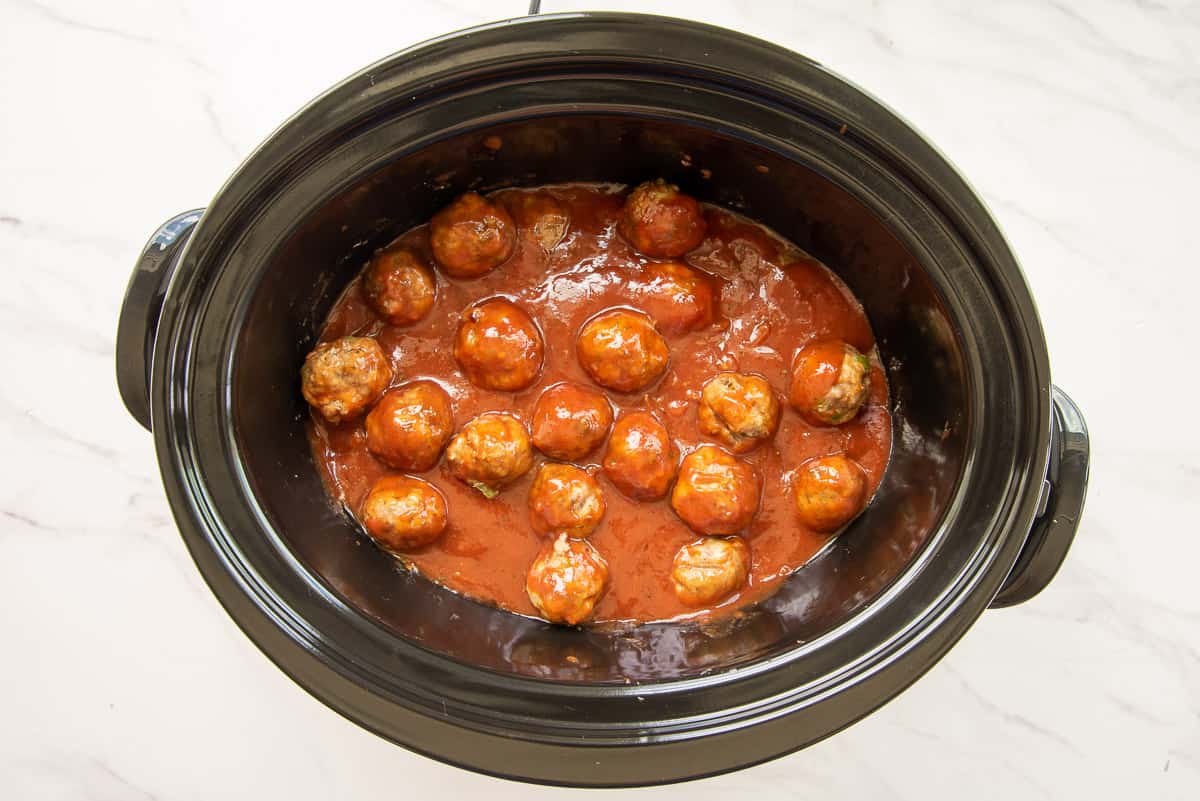 The party meatballs are kept warm in a slow cooker.