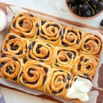 The baked Cherry Sweet Rolls are iced with the cream cheese icing.