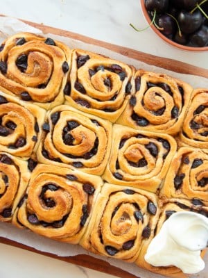 The baked Cherry Sweet Rolls are iced with the cream cheese icing.