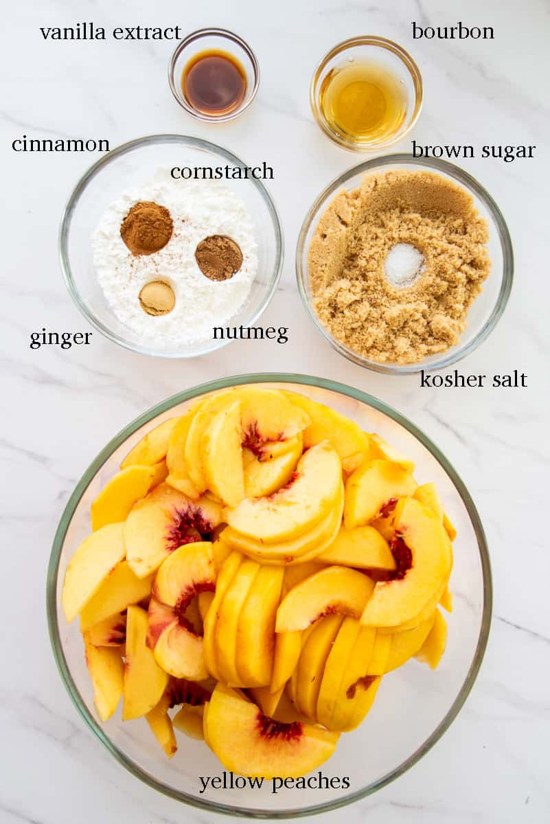 The ingredients needed to make Homemade Peach Cobbler are labeled in black on a white countertop.