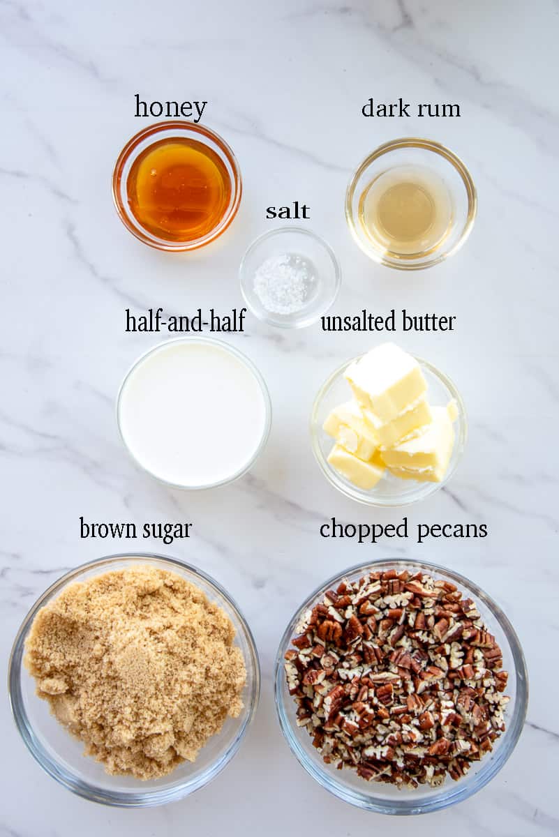 The ingredients needed to make the pecan praline topping are labeled on a white countertop.