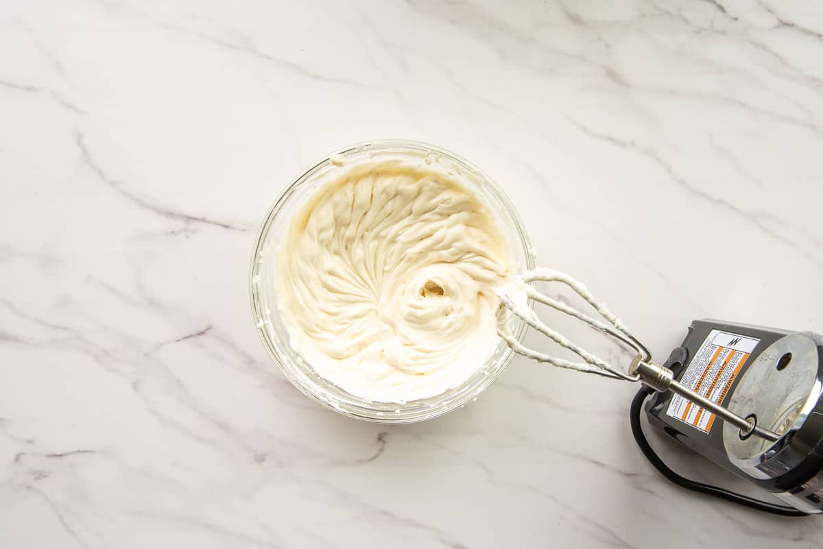 The cream cheese filling is blended until smooth by an electric hand mixer.