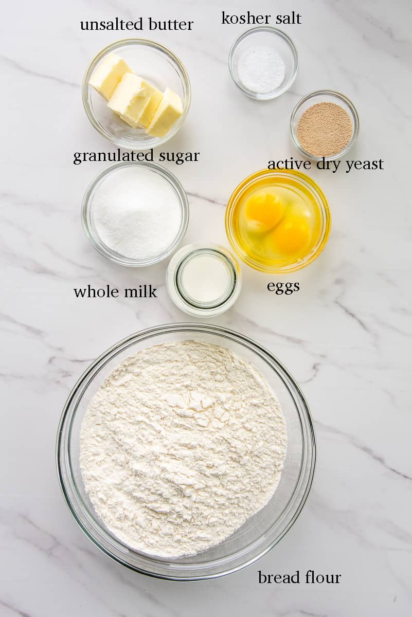 The ingredients needed to make Medianoche Bread are labeled on a white countertop.