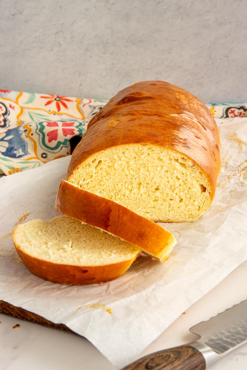 The baked Medianoche Bread is sliced to reveal the yellow interior.