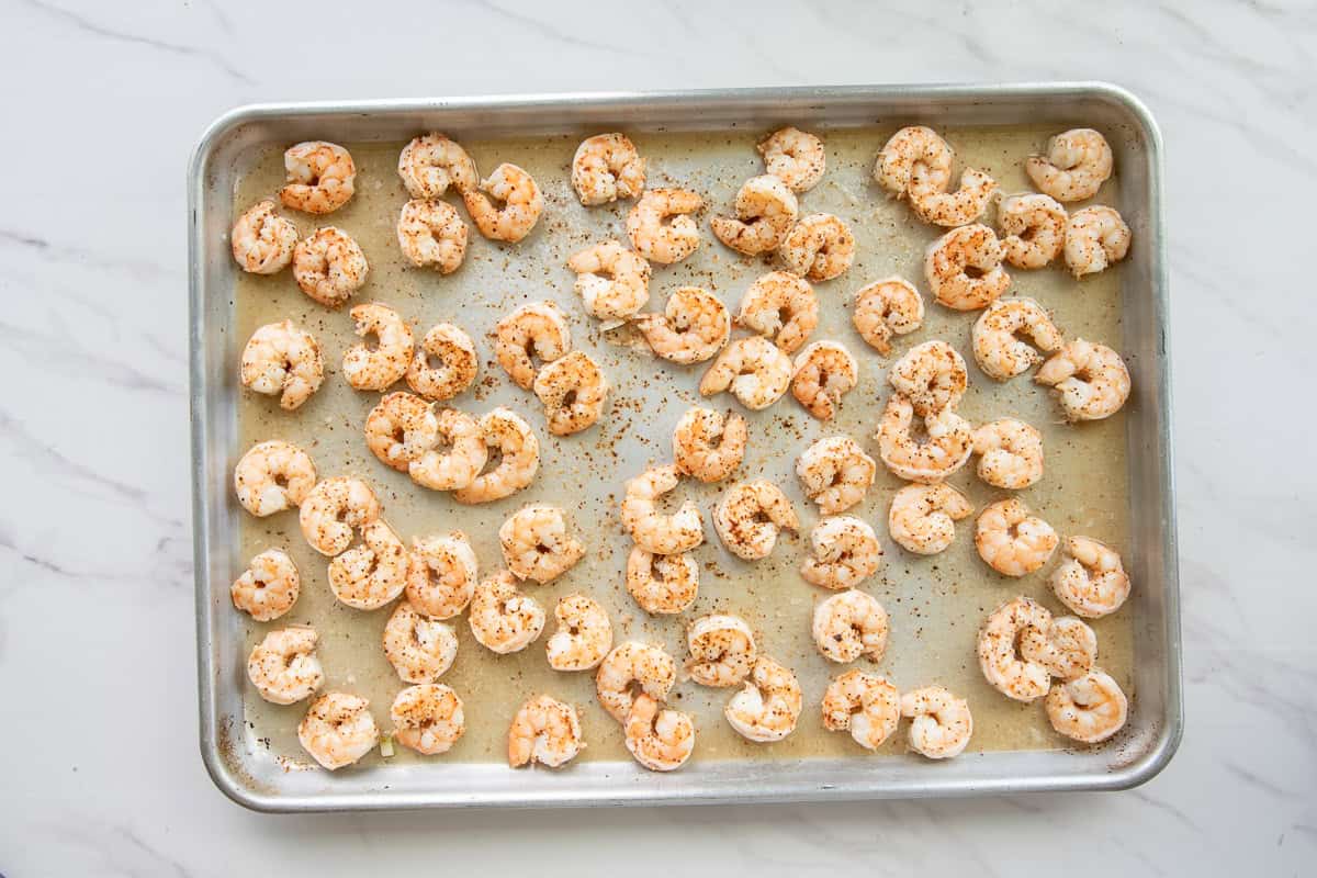 The roasted shrimp on a sheet pan.