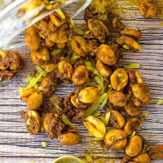 Toasted Coconut Curry Peanuts spilled onto a tabletop.