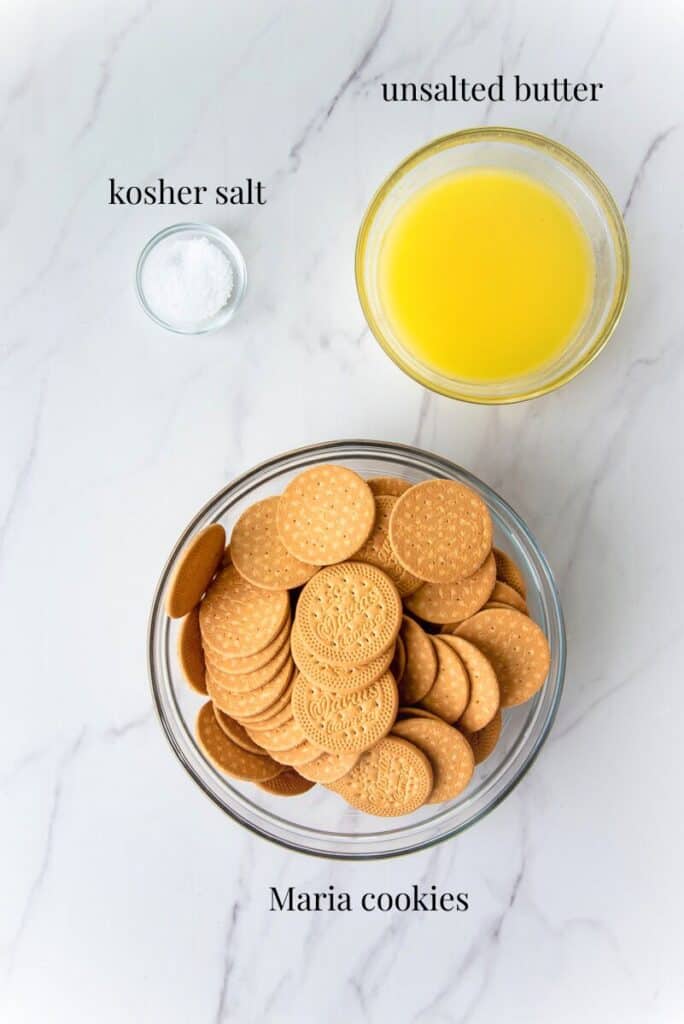 The ingredients to make the Cascos de Guayaba Cheesecake crust are labeled on a white countertop.