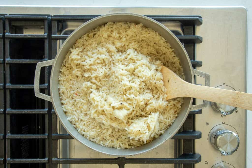 A wooden spoon is used to fluff the rice once it is finished steaming.
