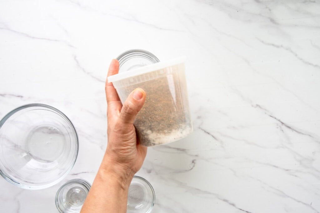 The ingredients are shaken together in a plastic deli container.