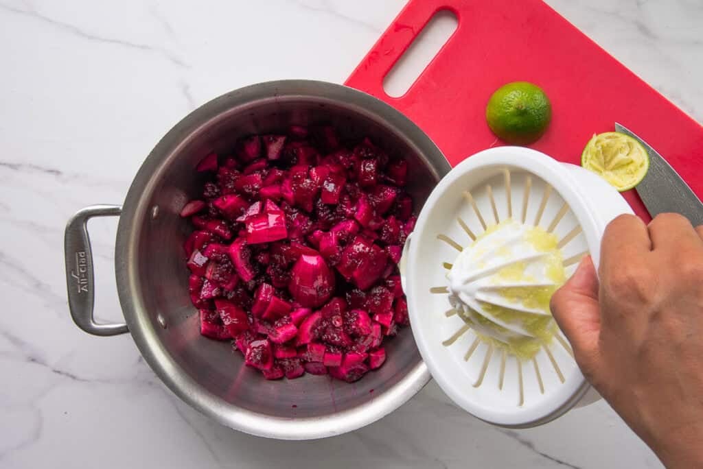 Lime juice is added to the pot with the chopped fruit.